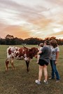 One of the many visitors at the farm enjoying and learning about longhorns.  Photo credit: TIfflynn Photography