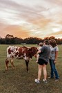 One of the many visitors at the farm enjoying and learning about longhorns.  Photo credit: TIfflynn Photography